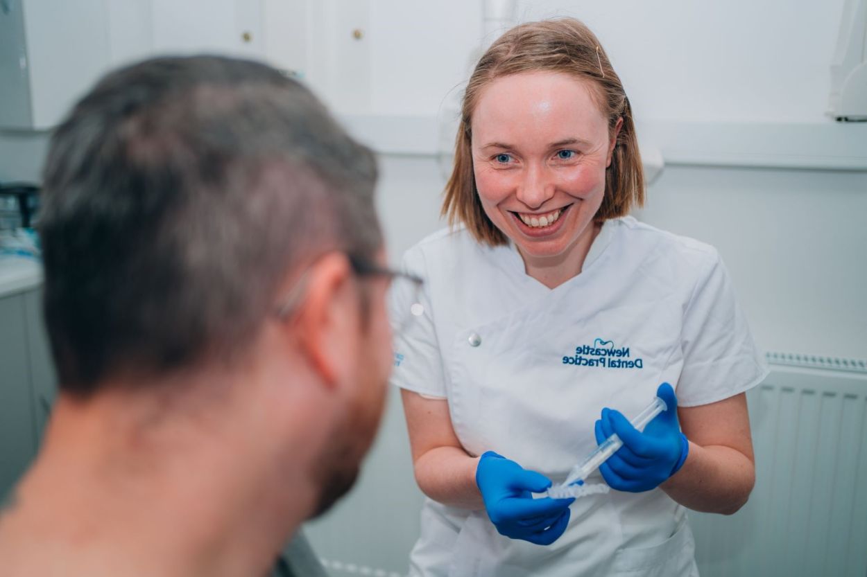 Dentist talking with a patient at Newcastle Dental Practice, Newcastle-under-Lyme